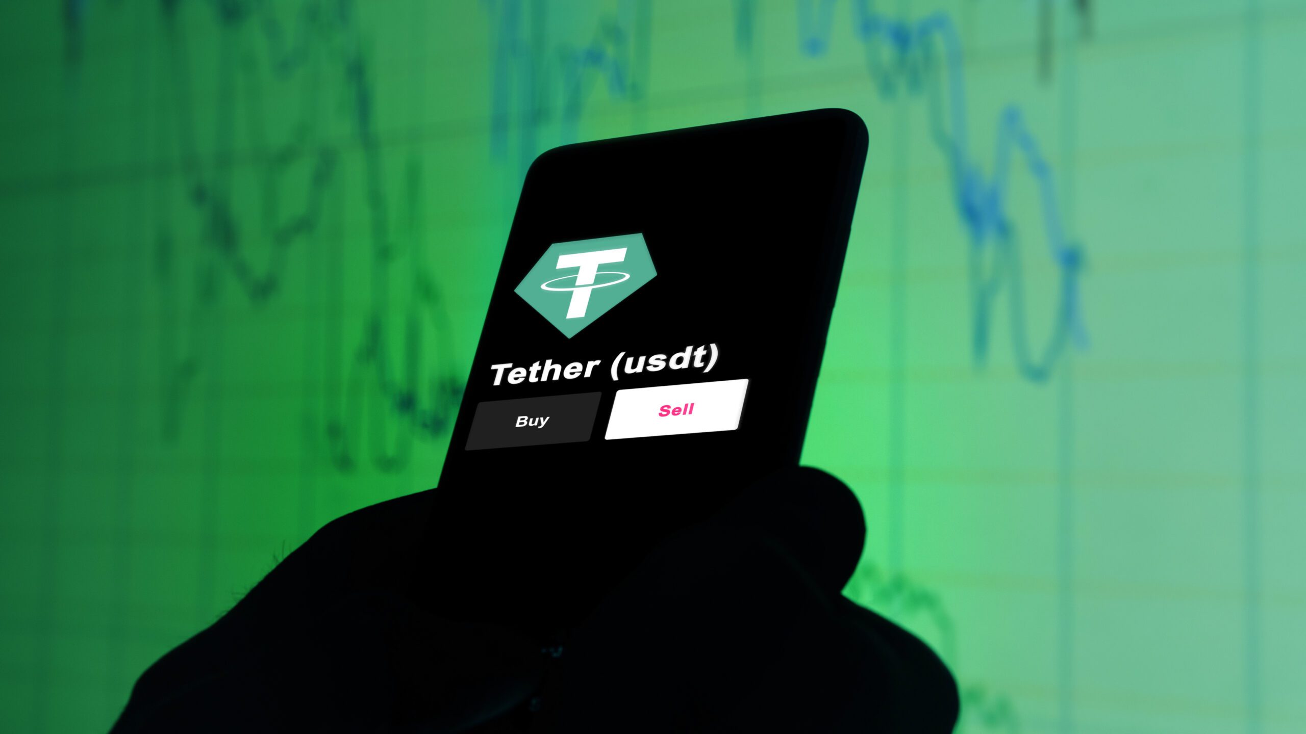 An investors analyzing the tether $usdt coin on screen A phone shows the USDT price to invest