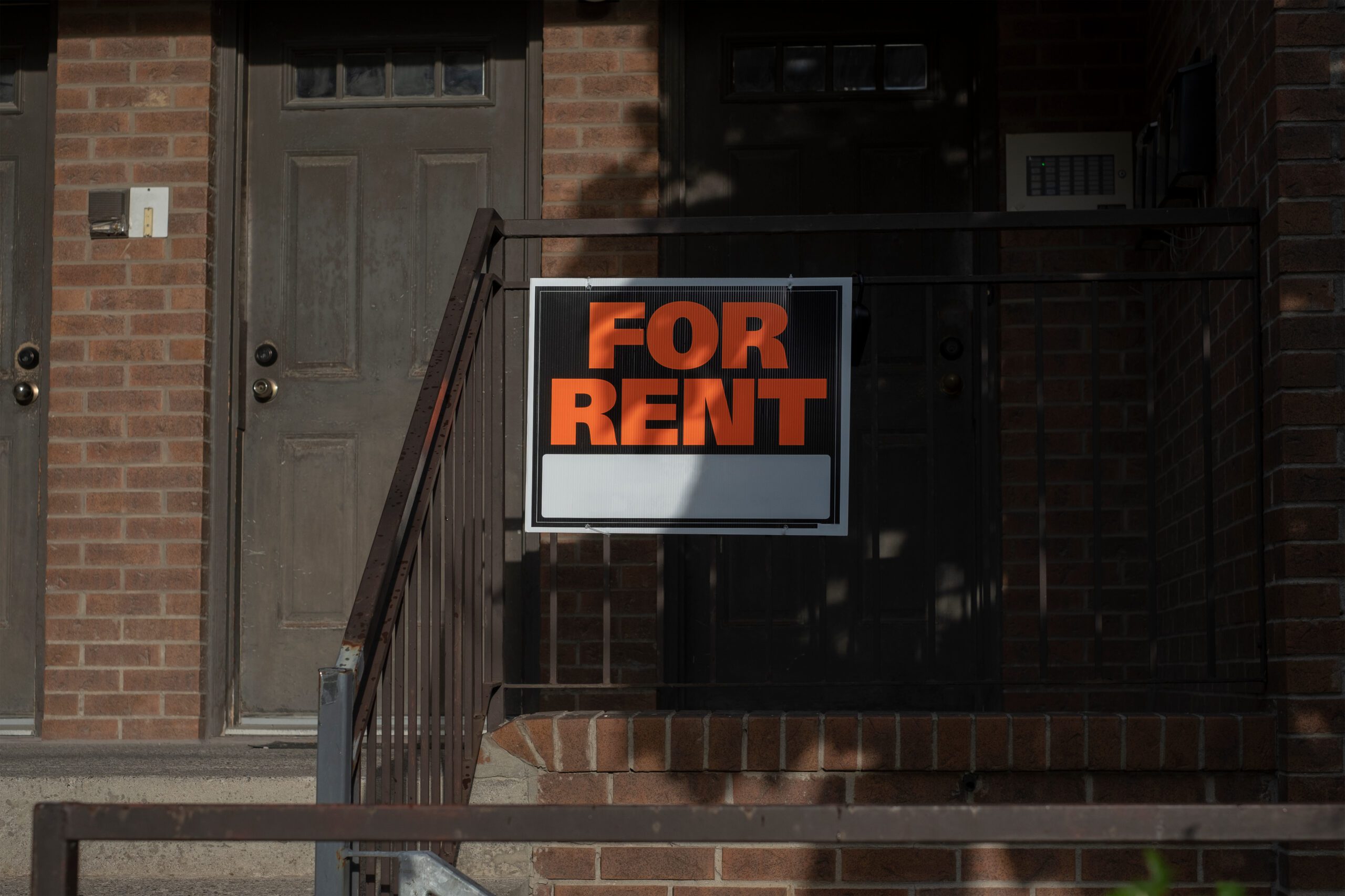 Sign for rent at the front of a residential house Affordable housing real estate crisis investment property concept